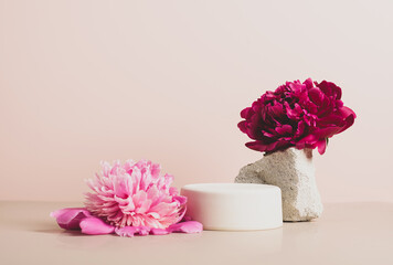 Modern podium wooden geometric shapes stone green fresh plant flowers peony pastel pink background....