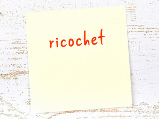 Yellow sticky note on wooden wall with handwritten word ricochet - obrazy, fototapety, plakaty