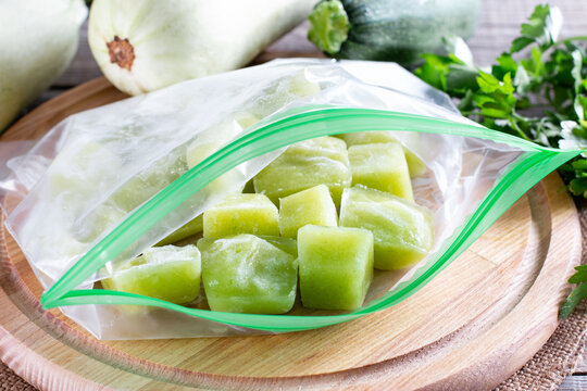 Frozen zucchini puree in a plastic bag on table. Frozen food Concept