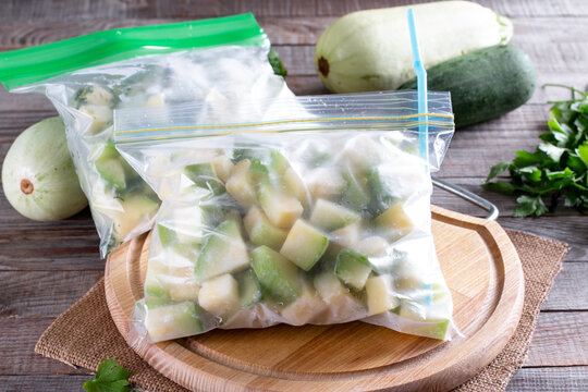 Frozen zucchini in a plastic bag on table. Frozen food Concept