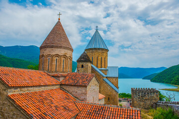 Georgia. Ananuri fortress. Stone walls. Clay tile. Mountain Lake.