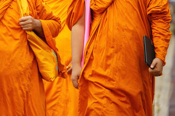 Thai buddhist monks carry on kitbag and walking to study