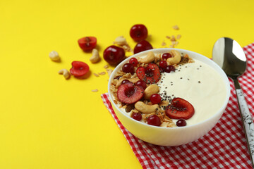 Concept of tasty breakfast with yogurt on yellow background