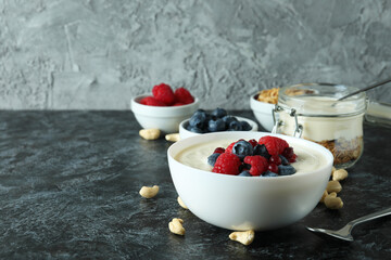 Concept of tasty breakfast with yogurt on black smokey table