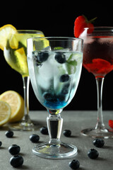 Fresh summer cocktails on gray textured table