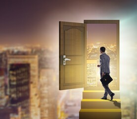 Businessman walking towards open door