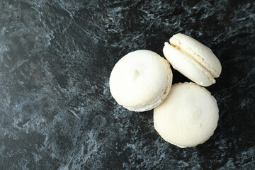 Concept of tasty dessert with macaroons on black smokey background