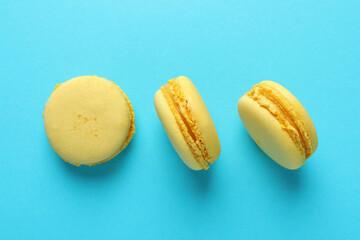Concept of tasty dessert with macaroons on blue background