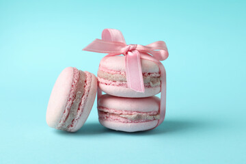 Concept of tasty dessert with macaroons on blue background
