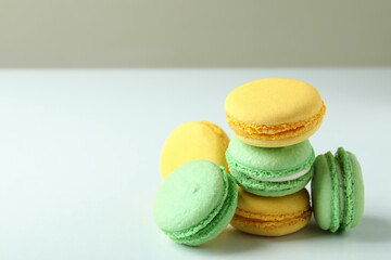 Concept of tasty dessert with macaroons on white background