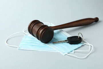 Judge gavel, key and medical masks on white background