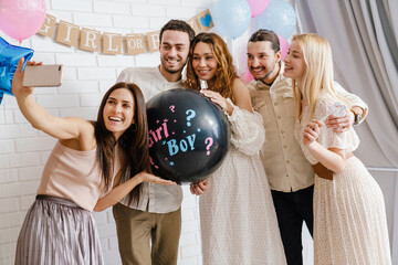 Happy young pregnant woman celebrating baby shower