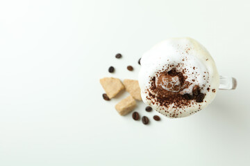 Glass of Irish coffee and ingredients on white background