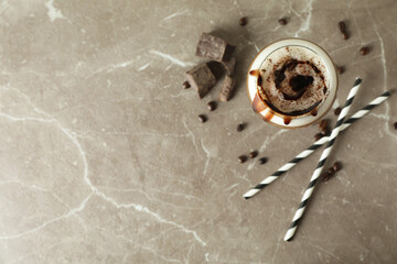 Glass of irish coffee on gray textured table