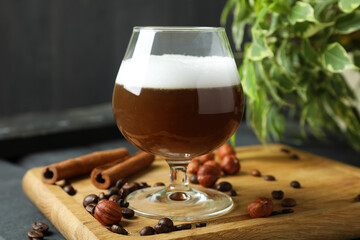 Concept of delicious drink with Irish coffee on wooden board