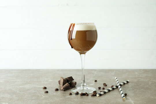 Glass of irish coffee on gray textured table
