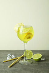 Glass of fresh citrus cocktail on gray table
