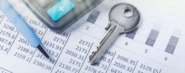 Real estate and investment concept. Calculator with finance blank, key and pen.