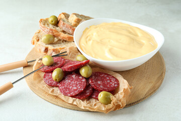 Concept of delicious food with fondue on white textured table