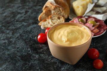 Concept of delicious food with fondue on black smokey table