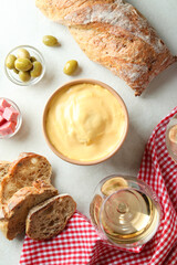 Concept of delicious food with fondue on white textured table