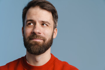 Fototapeta premium Brunette white man with beard smiling and looking aside