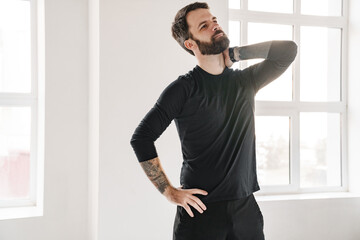 Calm mid aged bearded man in sportswear