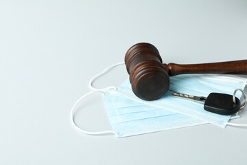 Judge gavel, key and medical masks on white background