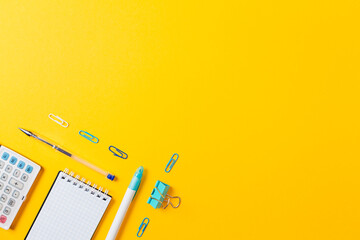 Back to schoo banner. Blue office supplies on yellow background. Flat lay. Copy space. Education...