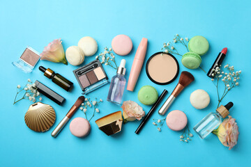 Female accessories and macaroons on blue background