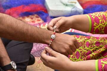 Obraz na płótnie Canvas Raksha Bandhan festival, Sister Tying Rakhi On Brother's Hand