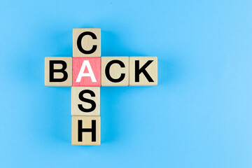 Wooden cubes with Cash Back Crossword on blue background. Cashback, Money, tax, business Financial planning concept.