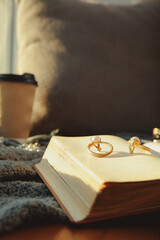 Open old book and accessories on table, closeup