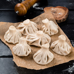 Georgian homemade food called khinkali. Georgian cuisine. On wooden background
