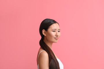 Beautiful young woman on color background