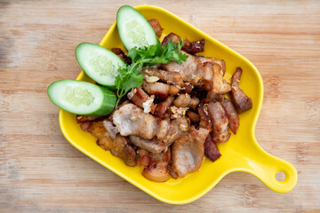 Deep fried pork belly with fish sauce and served with cucumber