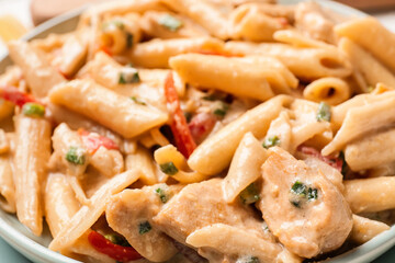 Plate with tasty cajun chicken pasta, closeup
