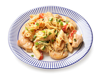 Plate with tasty cajun chicken pasta on white background