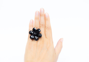 Black flower ring on girl hand isolate on white background, women accessory