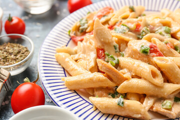 Plate with tasty cajun chicken pasta on color background, closeup