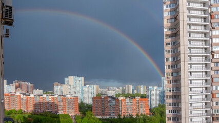 Moscow, Russia - May 16, 2020: Rainbow in the sky after spring rain over multi-story houses...