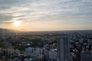 Fototapeta na wymiar 札幌の展望台から見た夕日の町並みの風景 A view of the city at sunset from the observatory in Sapporo