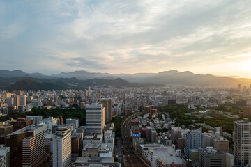 札幌の展望台から見た夕日の町並みの風景 A view of the city at sunset from the...