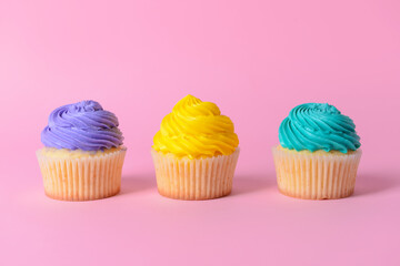 Tasty Birthday cupcakes on color background