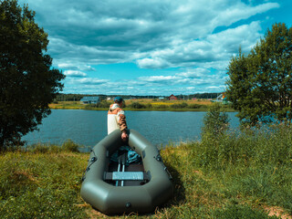 a fisherman with a boat goes down to the river