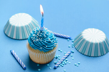 Composition with tasty Birthday cupcake and candles on color background, closeup