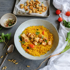Homemade Middle Eastern cuisine. Turmeric Rice with Crispy Tofu & Spiced Yogurt. Delicious and healthy diet for weight watcher and working professionals