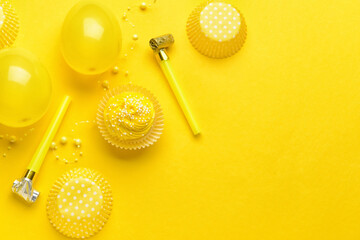 Composition with tasty Birthday cupcake, balloons and party whistles on color background