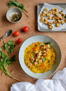 Homemade Middle Eastern cuisine. Turmeric Rice with Crispy Tofu & Spiced Yogurt. Delicious and healthy diet for weight watcher and working professionals
