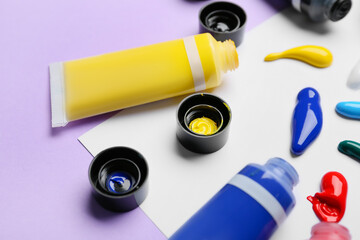 Tubes with paints on color background